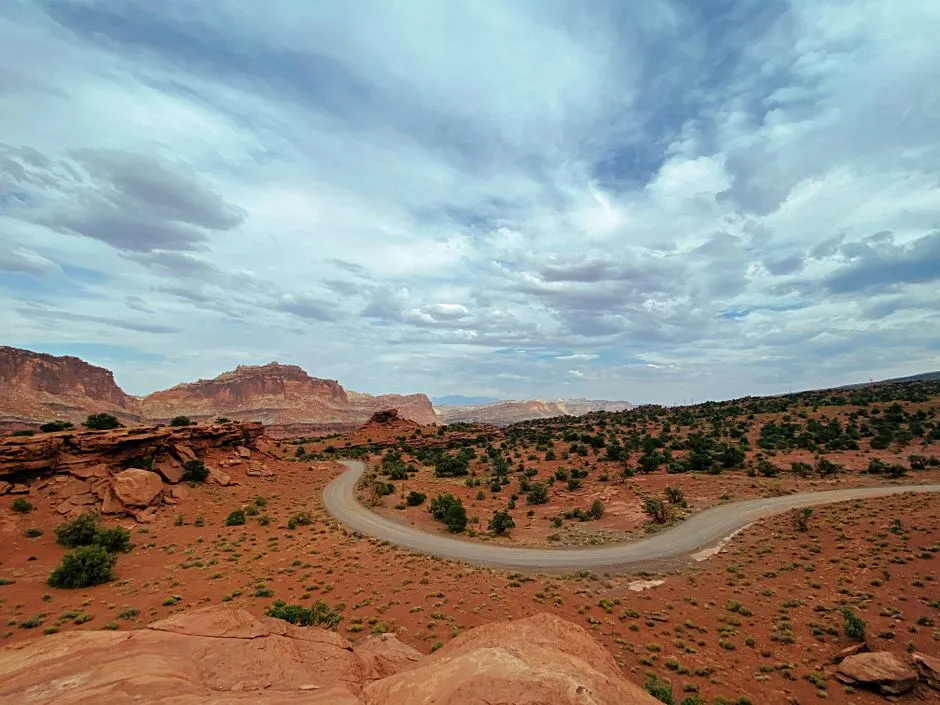 A dirt road winding through open public land under a wide sky
