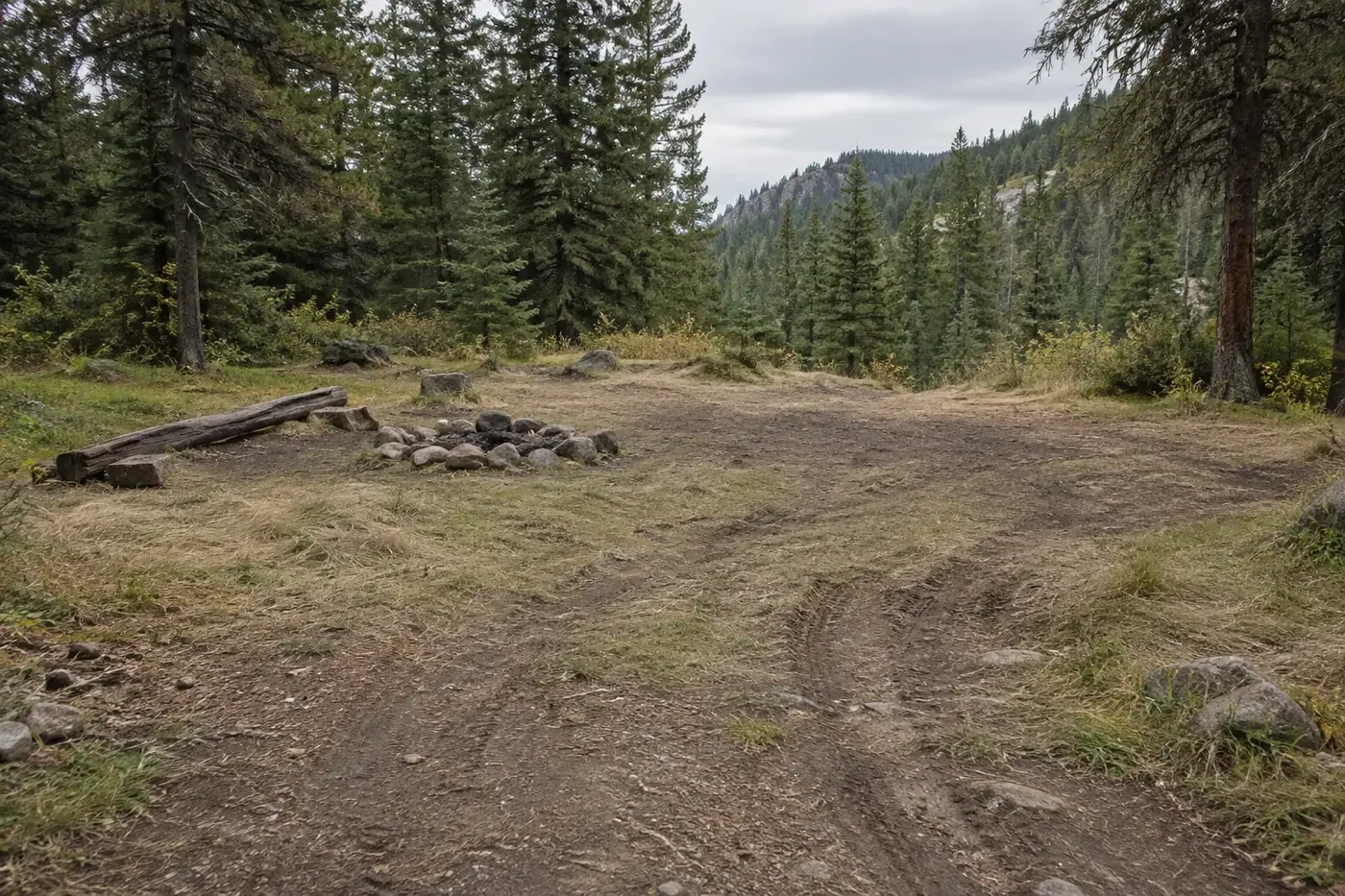 Illustration of a worn dirt clearing with visible tire tracks